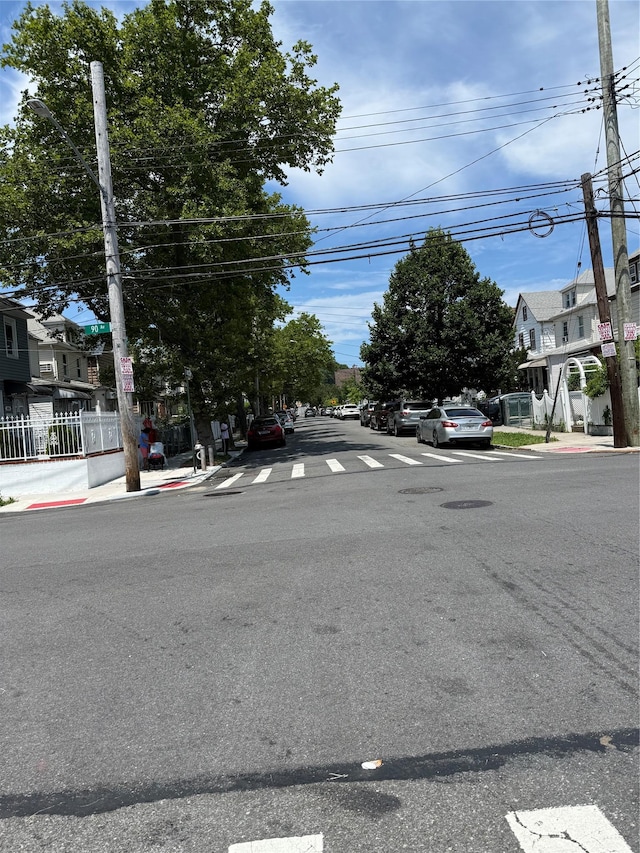 9030 202nd St, Hollis, NY 11423 - view of asphalt road with sidewalks, curbs, and a residential view
