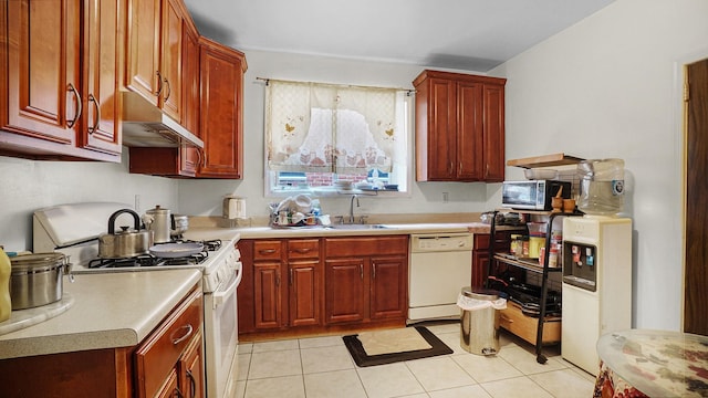 85-35 Parsons Blvd, Briarwood, NY 11435 - kitchen with white appliances, under cabinet range hood, light countertops, light tile patterned floors, and dark brown cabinets