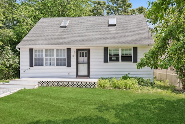 5 Coolidge Rd, Hampton Bays, NY 11946 - view of front of house featuring a front yard and a shingled roof