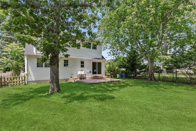 5 Coolidge Rd, Hampton Bays, NY 11946 - rear view of house with a fenced backyard and a deck
