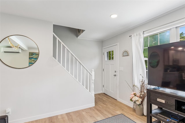 5 Coolidge Rd, Hampton Bays, NY 11946 - entryway featuring a wall mounted air conditioner, wood finished floors, healthy amount of natural light, stairway, and recessed lighting
