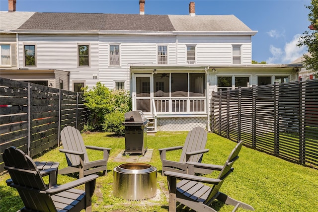 24 8th St, Hudson, NY 12534 - rear view of house featuring a fire pit, a chimney, a sunroom, a fenced backyard, and roof with shingles