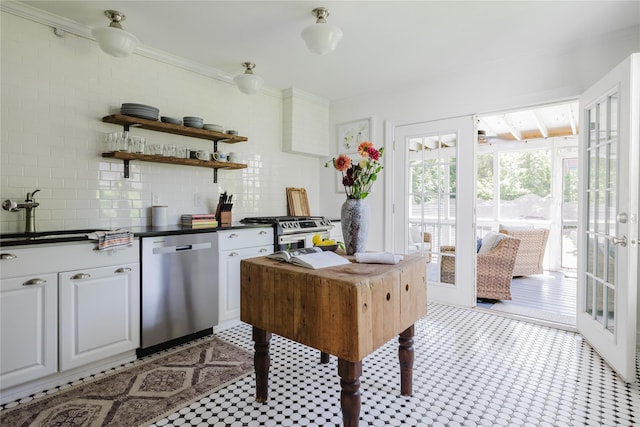 24 8th St, Hudson, NY 12534 - kitchen featuring stainless steel appliances, light flooring, dark countertops, open shelves, and tasteful backsplash