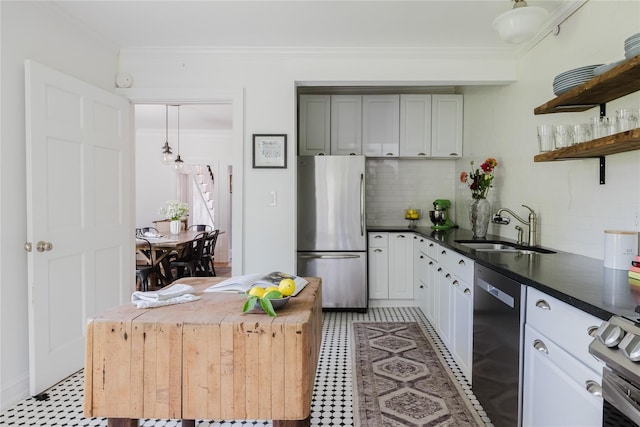 24 8th St, Hudson, NY 12534 - kitchen featuring appliances with stainless steel finishes, open shelves, decorative backsplash, dark countertops, and ornamental molding