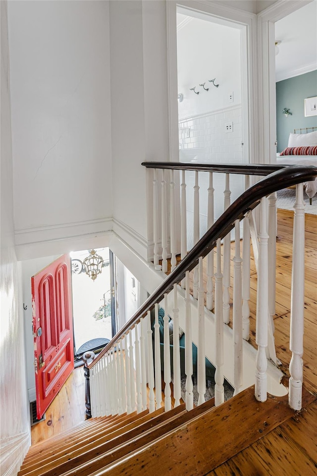 24 8th St, Hudson, NY 12534 - stairs with wood-type flooring and a chandelier