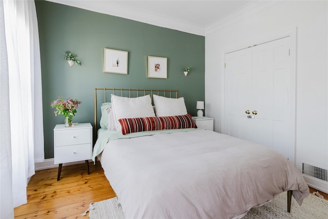 24 8th St, Hudson, NY 12534 - bedroom with ornamental molding, wood finished floors, and a closet