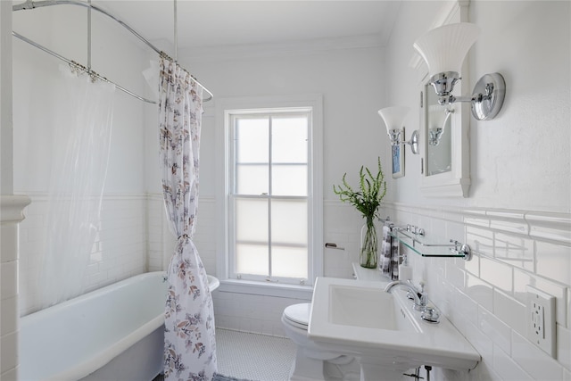 24 8th St, Hudson, NY 12534 - full bath with tile walls, plenty of natural light, shower / tub combo, crown molding, and wainscoting