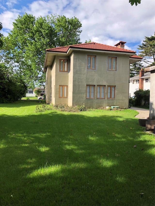 181 Walnut St, Lynbrook, NY 11563 - back of house with a yard and a chimney