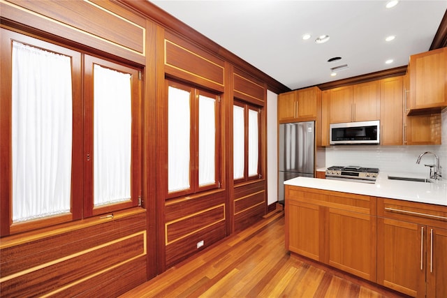 181 Walnut St, Lynbrook, NY 11563 - kitchen with stainless steel appliances, light countertops, backsplash, recessed lighting, and light wood-type flooring