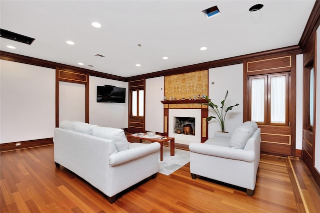181 Walnut St, Lynbrook, NY 11563 - living room with light wood-style flooring, a fireplace, recessed lighting, and ornamental molding
