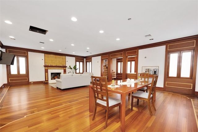 181 Walnut St, Lynbrook, NY 11563 - dining space featuring light wood-style flooring, a fireplace, crown molding, and recessed lighting