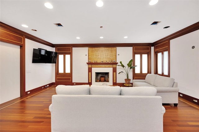181 Walnut St, Lynbrook, NY 11563 - living area featuring wood finished floors, healthy amount of natural light, recessed lighting, crown molding, and a fireplace