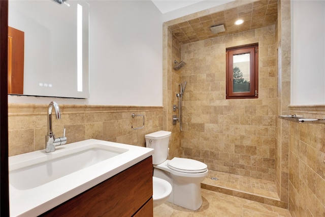 181 Walnut St, Lynbrook, NY 11563 - bathroom with tile walls, tiled shower, vanity, a bidet, and wainscoting