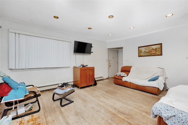181 Walnut St, Lynbrook, NY 11563 - living room featuring a baseboard heating unit, light wood-style flooring, and recessed lighting