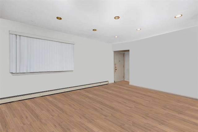 181 Walnut St, Lynbrook, NY 11563 - empty room with baseboard heating, light wood-style floors, and recessed lighting
