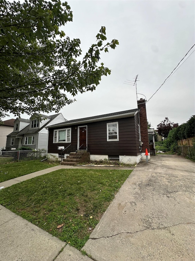 100 Atlantic Ave, Staten Island, NY 10304 - view of front facade with a chimney and concrete driveway