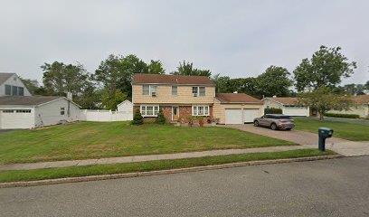 38 Tulip Grove Dr, Lake Grove, NY 11755 - view of front facade featuring an attached garage and asphalt driveway