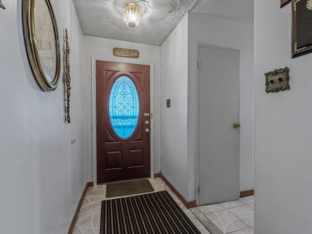 453 Christopher Ave, Brooklyn, NY 11212 - entryway featuring light tile patterned floors and a textured ceiling