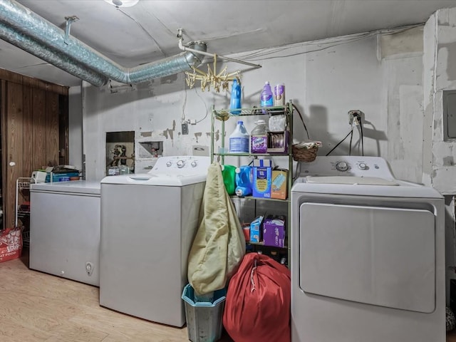 453 Christopher Ave, Brooklyn, NY 11212 - laundry area featuring washing machine and clothes dryer, wood finished floors, and wood walls