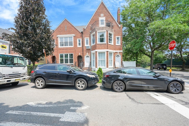6851 Clyde St, Forest Hills, NY 11375 - view of front of property featuring brick siding and a chimney
