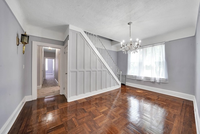 6851 Clyde St, Forest Hills, NY 11375 - unfurnished dining area featuring healthy amount of natural light, stairway, a chandelier, and a textured ceiling