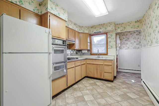 12 Malone Ave, Garnerville, NY 10923 - kitchen with appliances with stainless steel finishes, baseboard heating, wallpapered walls, light countertops, and a wainscoted wall