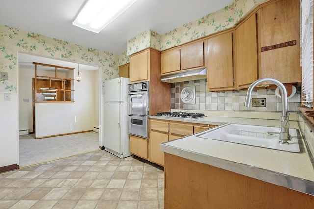 12 Malone Ave, Garnerville, NY 10923 - kitchen with wallpapered walls, appliances with stainless steel finishes, light countertops, under cabinet range hood, and tasteful backsplash