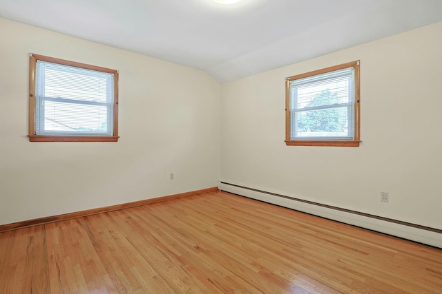 12 Malone Ave, Garnerville, NY 10923 - empty room featuring a baseboard radiator, vaulted ceiling, and light wood finished floors