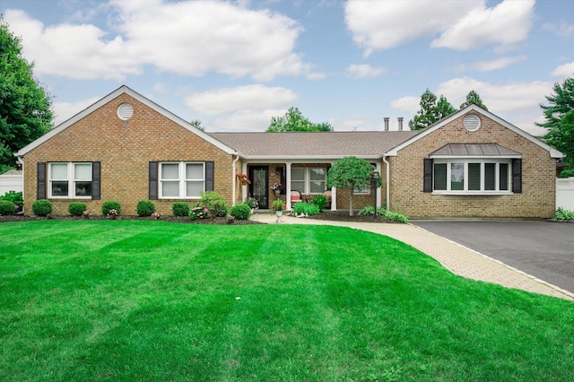 31-33 Dunlop Ct, Commack, NY 11725 - ranch-style home with brick siding and a front lawn