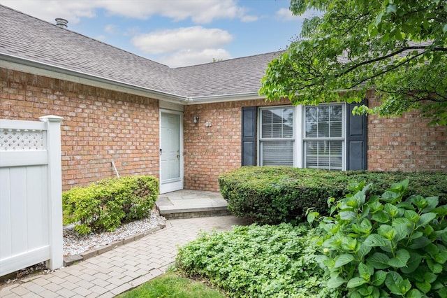 31-33 Dunlop Ct, Commack, NY 11725 - property entrance featuring brick siding and roof with shingles