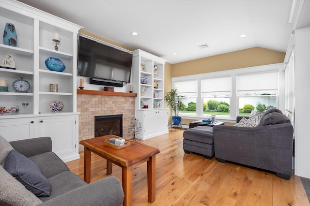 31-33 Dunlop Ct, Commack, NY 11725 - living area featuring light wood-type flooring, a brick fireplace, recessed lighting, and vaulted ceiling