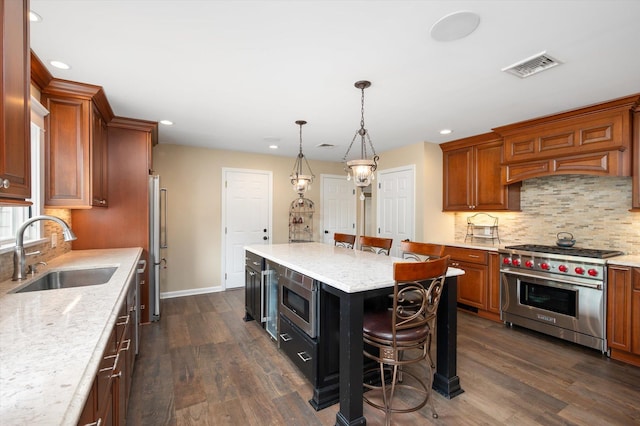31-33 Dunlop Ct, Commack, NY 11725 - kitchen with stainless steel appliances, brown cabinets, dark wood finished floors, recessed lighting, and tasteful backsplash