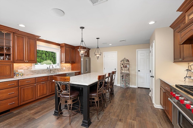 31-33 Dunlop Ct, Commack, NY 11725 - kitchen with high quality appliances, a kitchen breakfast bar, tasteful backsplash, dark wood-style floors, and glass insert cabinets