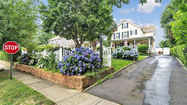 16 Clement St, Glen Cove, NY 11542 - view of front of property with asphalt driveway, covered porch, and a gate