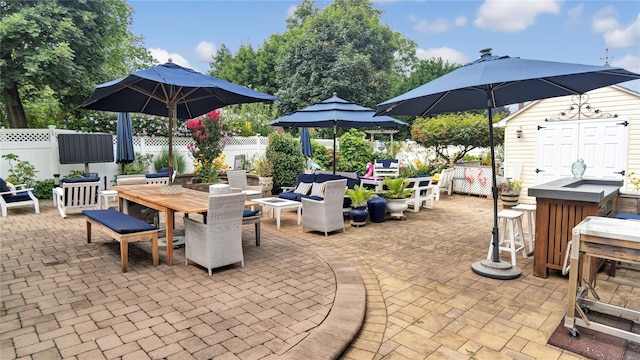 16 Clement St, Glen Cove, NY 11542 - fenced backyard with outdoor dining area, a patio, and a shed