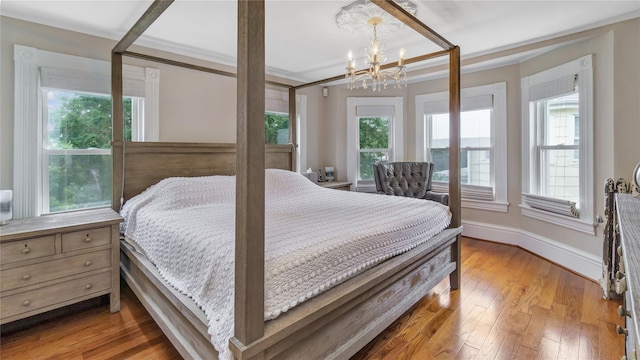 16 Clement St, Glen Cove, NY 11542 - bedroom with a chandelier and light wood-type flooring