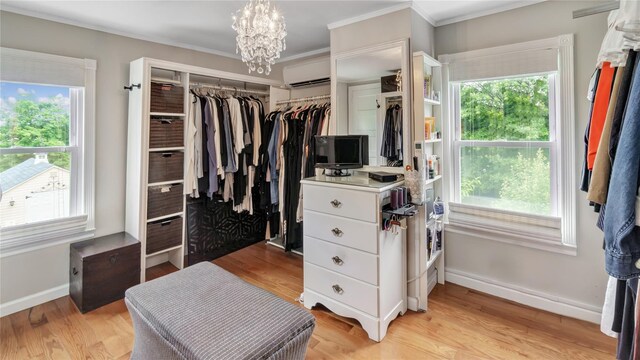 16 Clement St, Glen Cove, NY 11542 - walk in closet featuring a wall mounted AC, a chandelier, and light wood-style floors