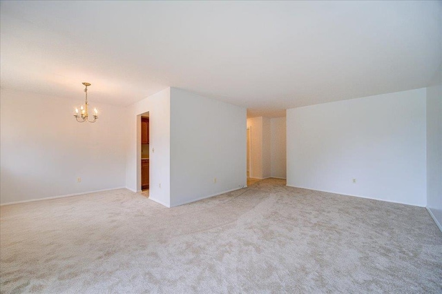 1109 Cherry Hill Dr Unit 1109, Poughkeepsie, NY 12603 - unfurnished room with a chandelier and light colored carpet