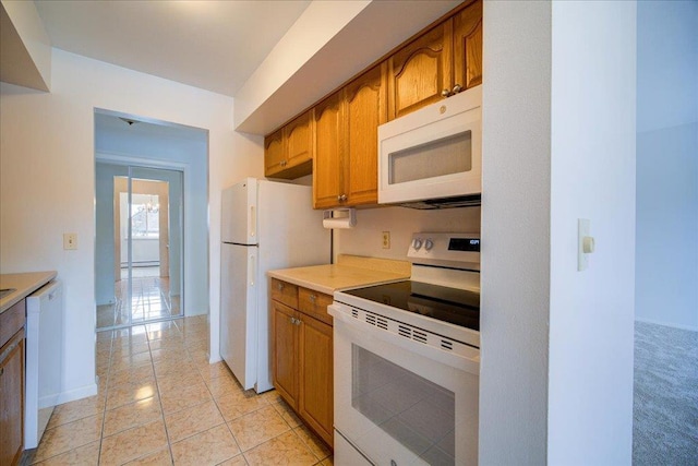 1109 Cherry Hill Dr Unit 1109, Poughkeepsie, NY 12603 - kitchen featuring white appliances, light countertops, brown cabinetry, and light tile patterned flooring