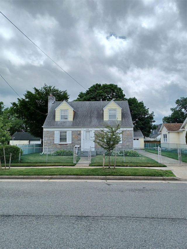 118 Allen St, Hempstead, NY 11550 - cape cod-style house with stone siding, a fenced front yard, and a chimney