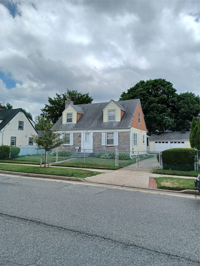 118 Allen St, Hempstead, NY 11550 - new england style home with stone siding, a chimney, driveway, and an outbuilding