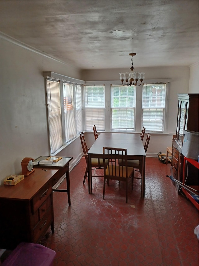 118 Allen St, Hempstead, NY 11550 - dining area featuring a chandelier and baseboards