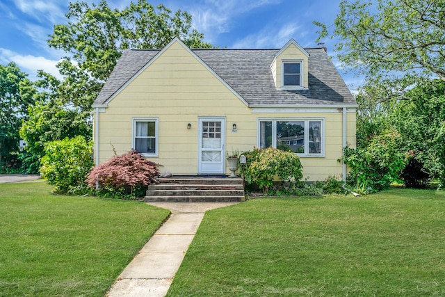 4 Jones St N, Patchogue, NY 11772 - view of front of property featuring a front yard and a shingled roof