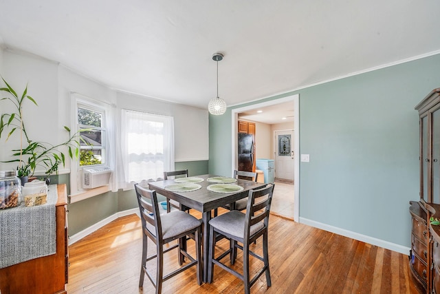 4 Jones St N, Patchogue, NY 11772 - dining space featuring light wood-style flooring, crown molding, and cooling unit