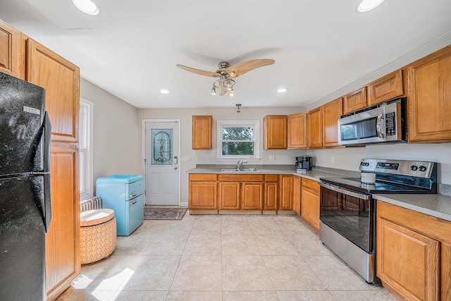 4 Jones St N, Patchogue, NY 11772 - kitchen with stainless steel appliances, a ceiling fan, brown cabinets, light countertops, and recessed lighting