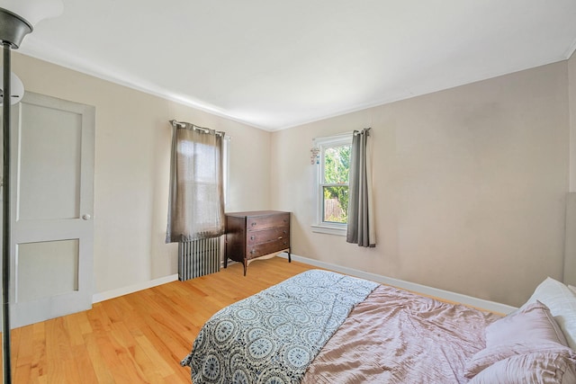 4 Jones St N, Patchogue, NY 11772 - bedroom featuring wood finished floors and radiator