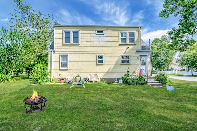 4 Jones St N, Patchogue, NY 11772 - back of property with an outdoor fire pit and a yard