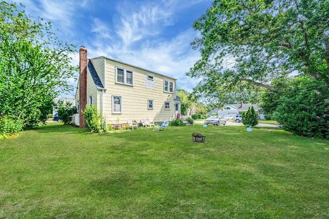 4 Jones St N, Patchogue, NY 11772 - back of house featuring a chimney and a yard