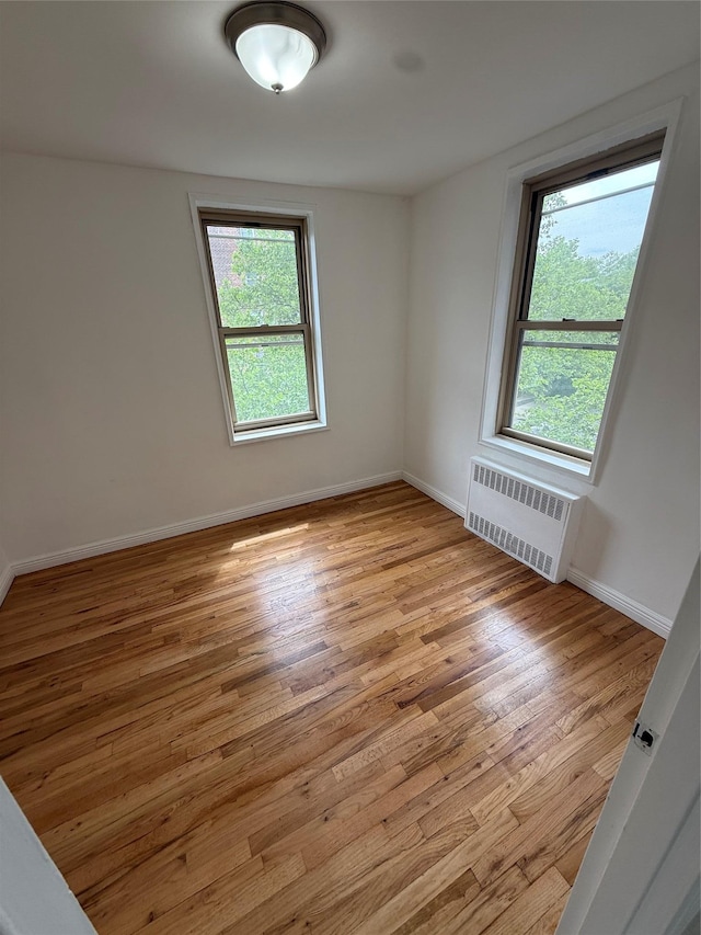 67-25 Clyde St Unit 5D, Forest Hills, NY 11375 - spare room featuring radiator and light wood-type flooring