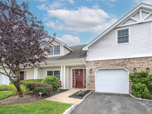 195 Pond View Dr Unit Ca0208, Port Washington, NY 11050 - view of front facade featuring stone siding, a garage, asphalt driveway, and a shingled roof
